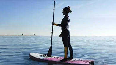 female on paddle board in water
