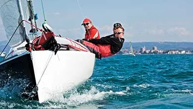 Male steering a sail boat
